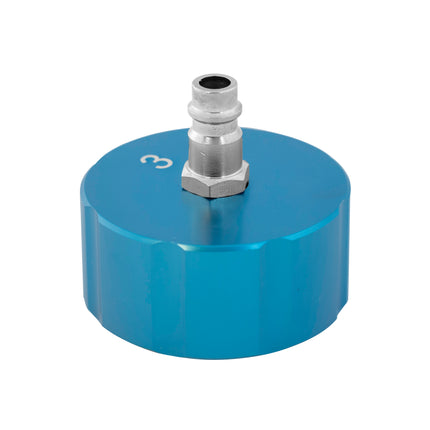 A blue metal cooling system cap with a silver-colored threaded insert and a label with the number 3 on it.