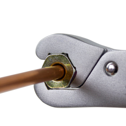 Lockjaw wrench shown gripping a nut on the end of a pipe